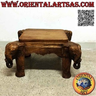 Low coffee table with elephant head on the four corners in teak wood