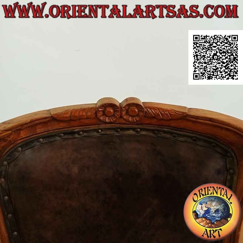 Imperial armchair with back, bottom and armrests covered in leather and flowers carved in teak wood