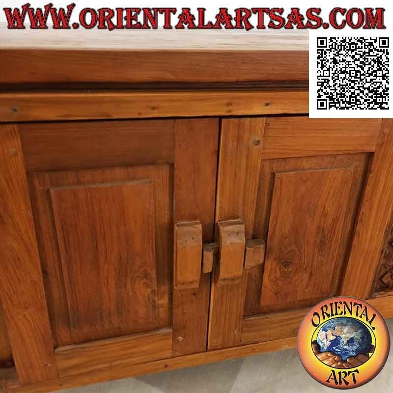 Antique Java buffet with wooden closures and hinges and panels with carved flowers in teak wood