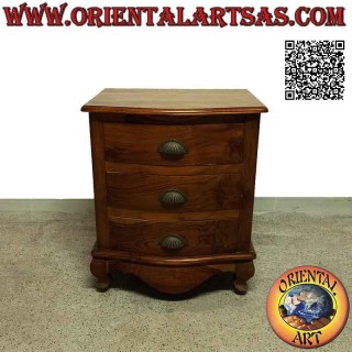 Rounded bedside table with three drawers with curved feet and brass handles in teak wood