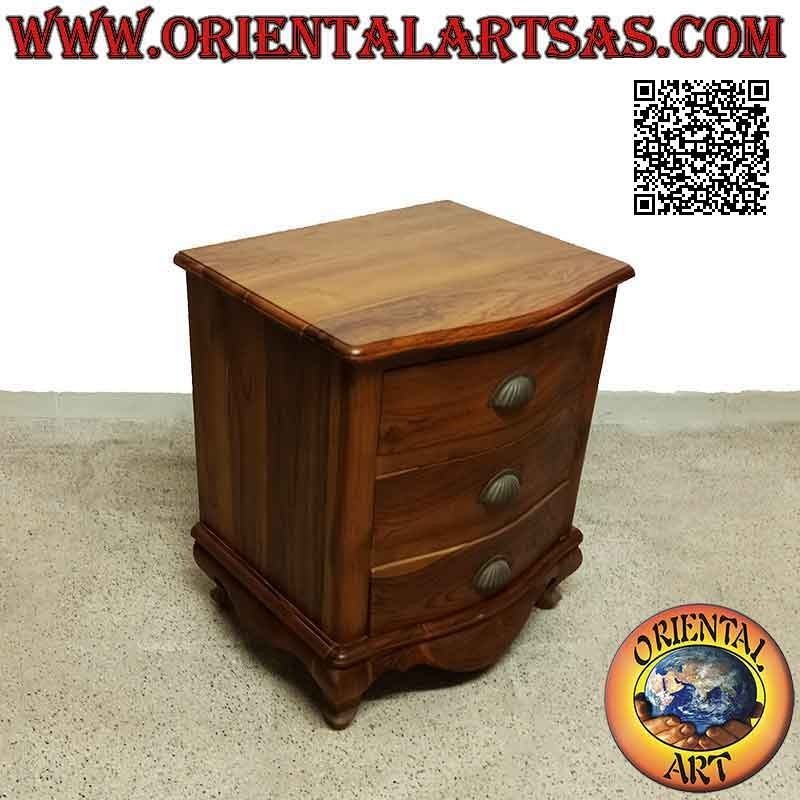 Rounded bedside table with three drawers with curved feet and brass handles in teak wood