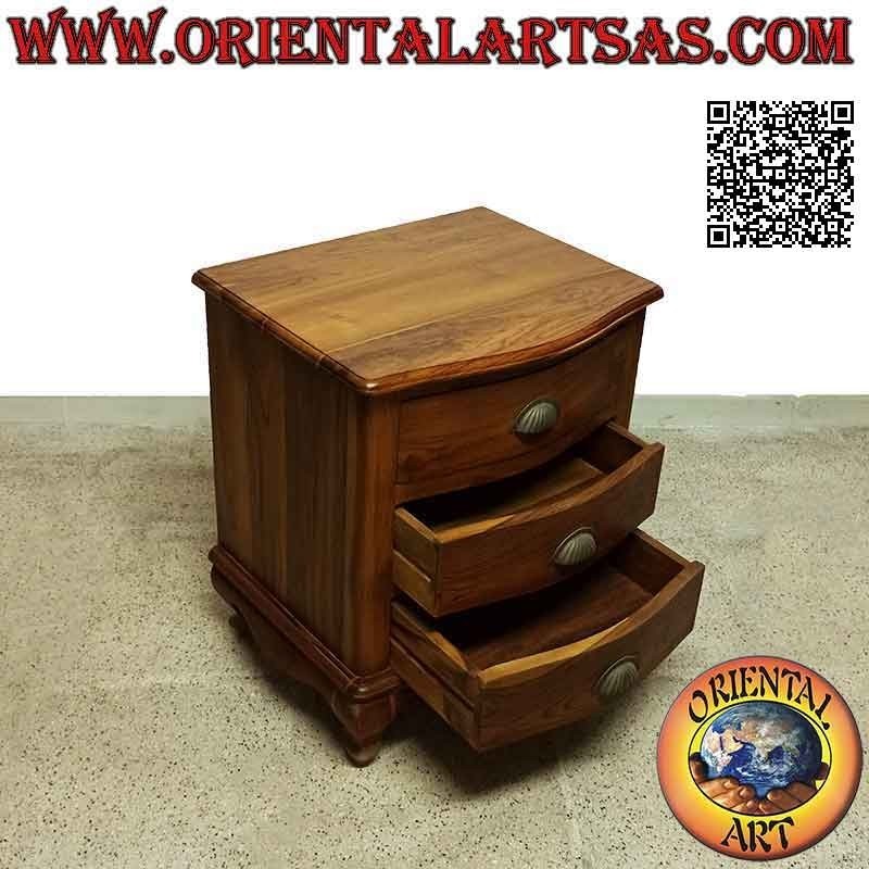 Rounded bedside table with three drawers with curved feet and brass handles in teak wood