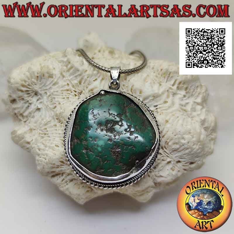 Antique silver pendant with irregular natural Tibetan turquoise surrounded by interweaving