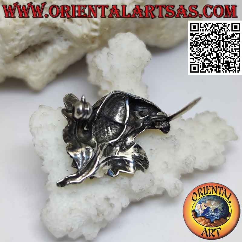 Silver brooch, eagle face in profile with flower on the neck