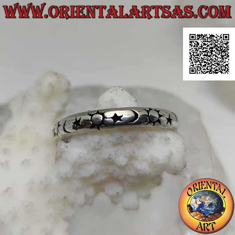 Silver band ring worked with a series of stylized sun, moon and star engraved