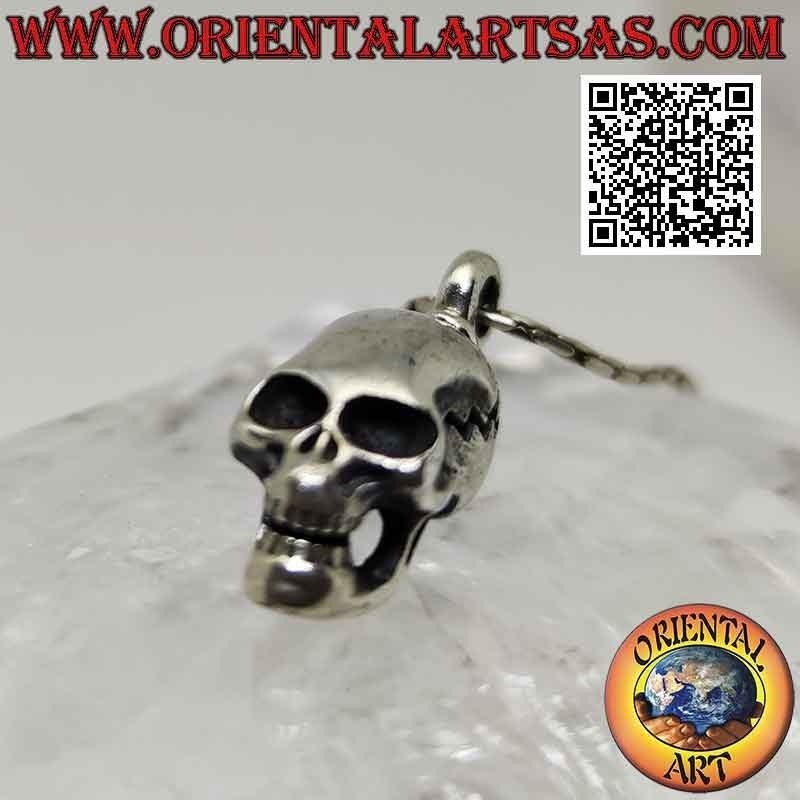 Silver pendant in the shape of a Skull (homo sapiens) with an elongated skull