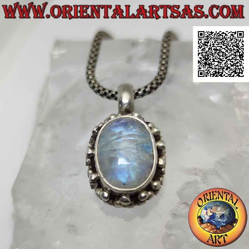 Silver pendant with cabochon oval moonstone surrounded by a double row of balls and tris