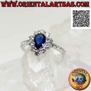 Silver ring with synthetic teardrop sapphire surrounded by round white zircons and on the sides