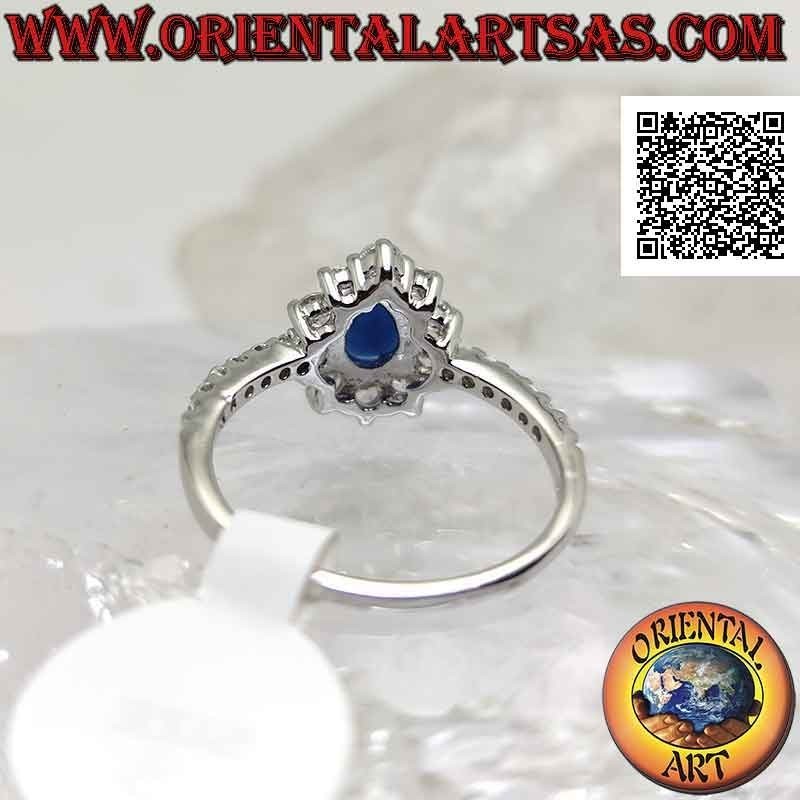 Silver ring with synthetic teardrop sapphire surrounded by round white zircons and on the sides