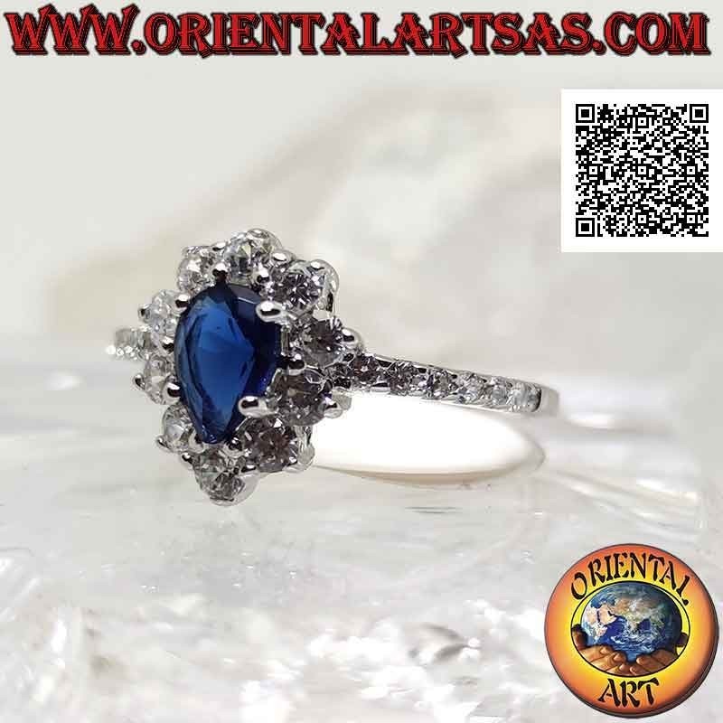 Silver ring with synthetic teardrop sapphire surrounded by round white zircons and on the sides