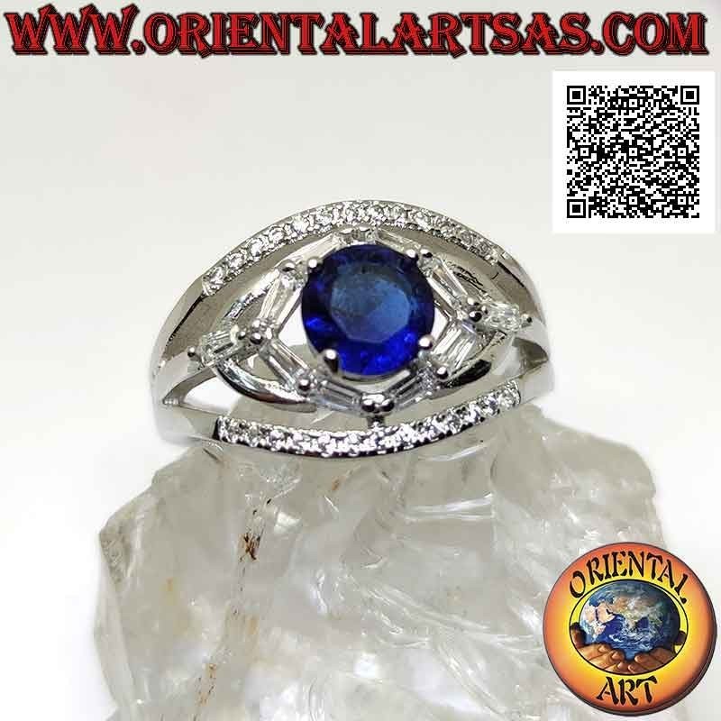 Silver ring with round synthetic sapphire set between elliptical games of white zircons
