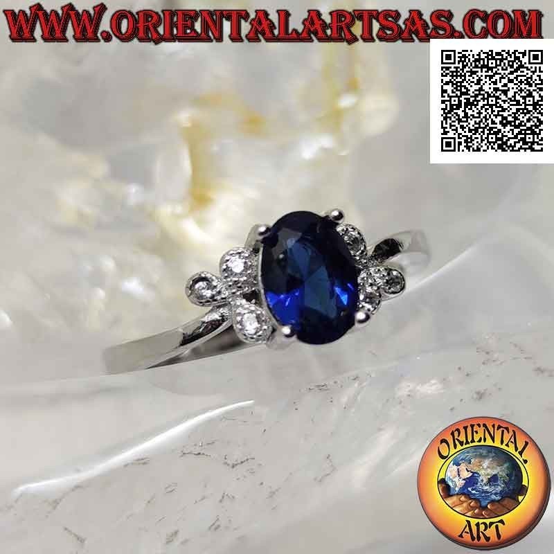 Anillo de plata con zafiro sintético ovalado engastado y tres circonitas blancas en los laterales