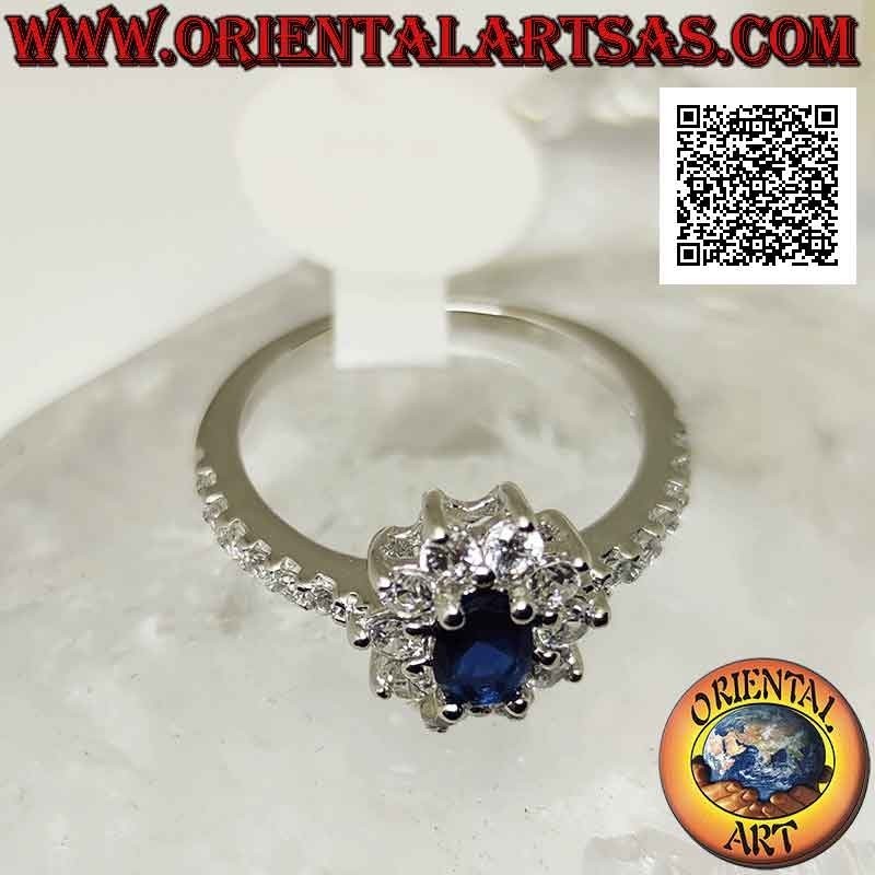 Anillo de plata con flor de circonita blanca engastada con zafiro sintético ovalado y circonita en los lados