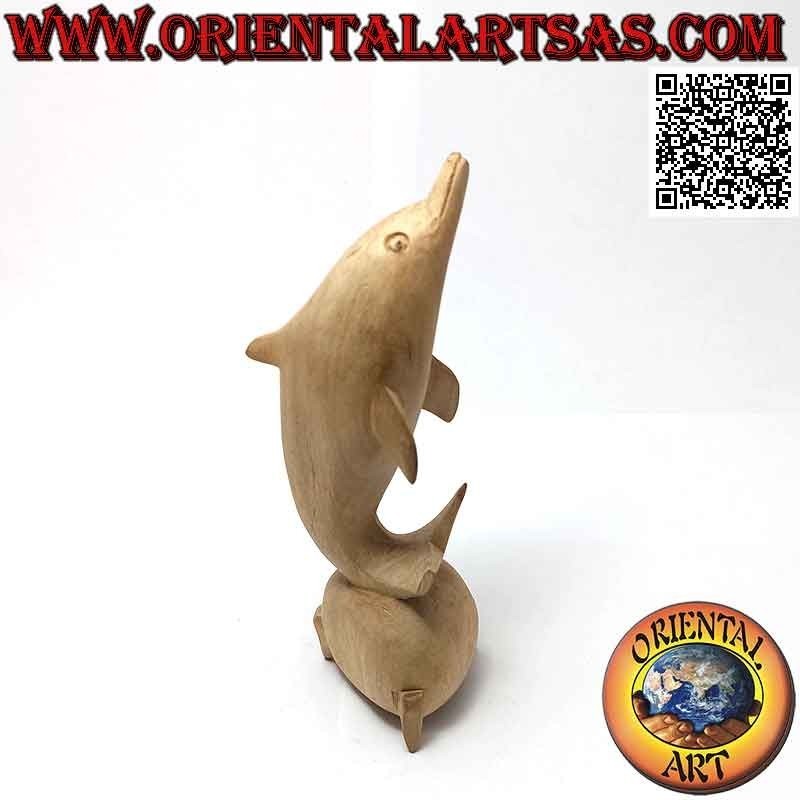 Sculpture of a dolphin juggling between two 15 cm hibiscus wood balls