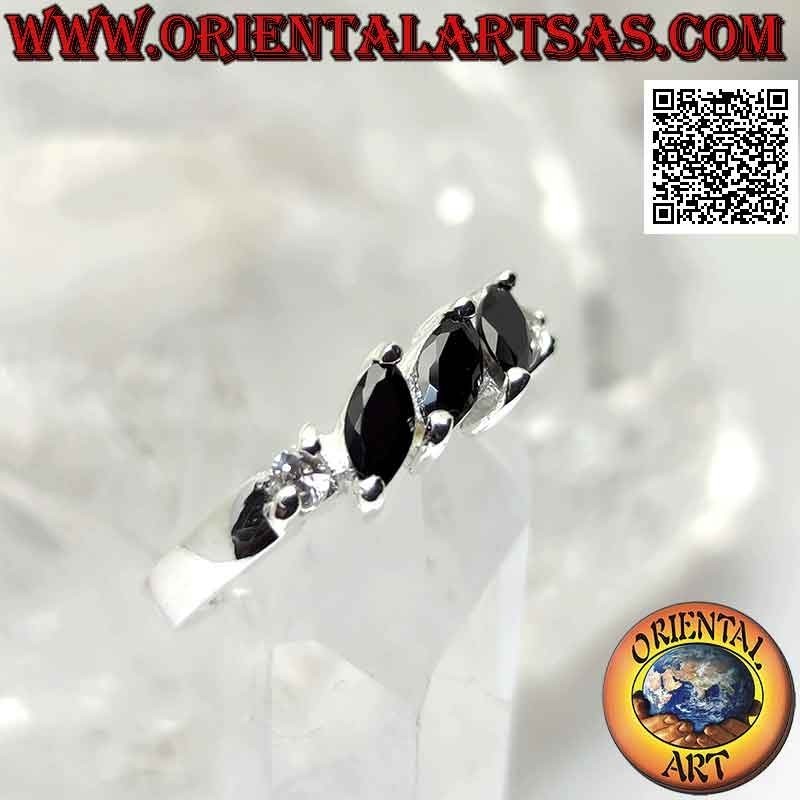 Silver ring with three shuttle spinels set obliquely between two round zircons