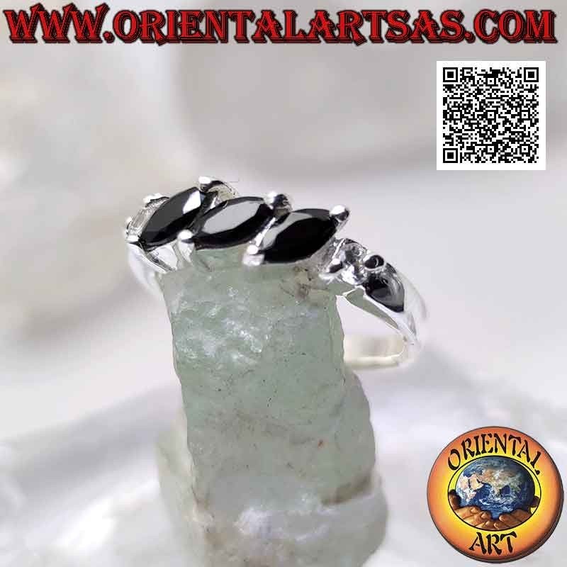 Silver ring with three shuttle spinels set obliquely between two round zircons