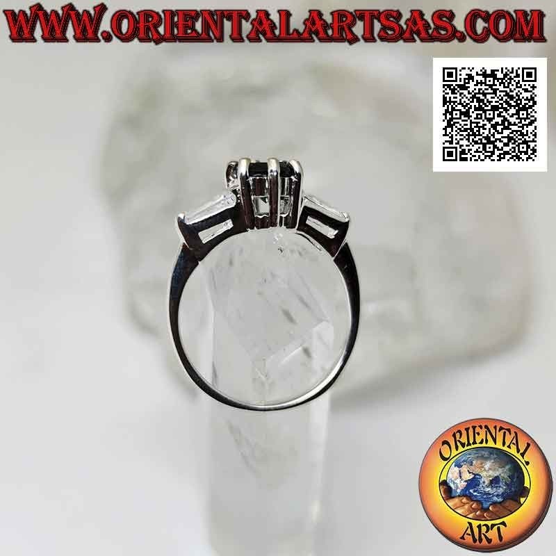 Silver ring with spinel set between two white trapezoid zircons