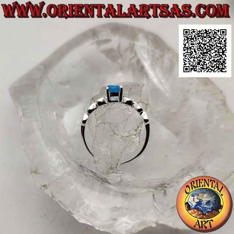 Anillo solitario de plata con topacio azul sintético redondo engastado y corazones perforados en los laterales