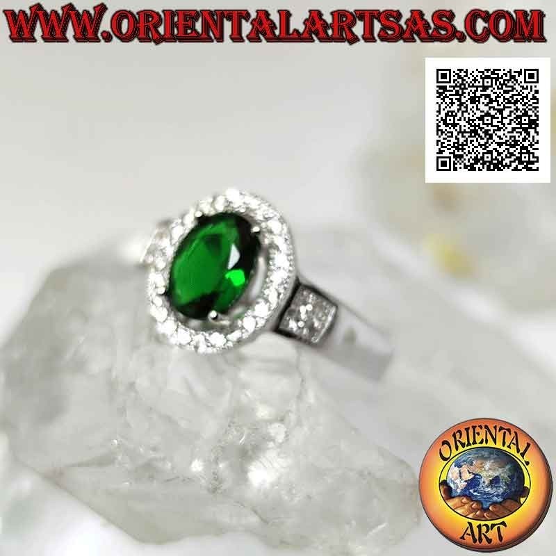 Silver ring with oval synthetic emerald set surrounded by zircons and square on the sides