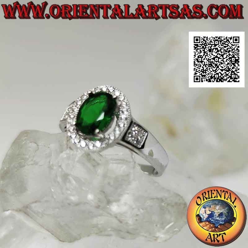 Silver ring with oval synthetic emerald set surrounded by zircons and square on the sides