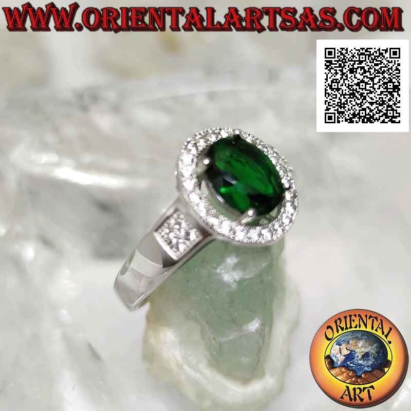 Silver ring with oval synthetic emerald set surrounded by zircons and square on the sides