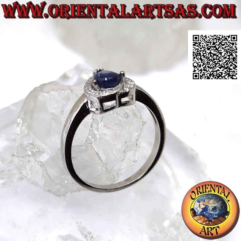 Silver ring with synthetic teardrop sapphire set surrounded by zircons with superimposed terminal