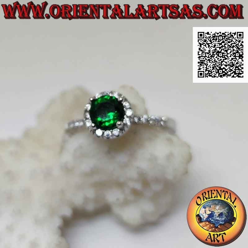 Silver ring with round synthetic emerald set surrounded by white zircons and on the sides