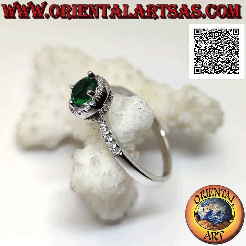Silver ring with round synthetic emerald set surrounded by white zircons and on the sides