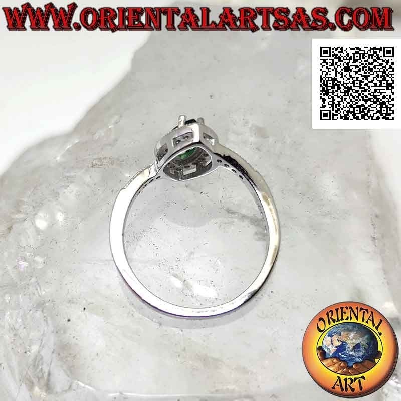 Silver ring with synthetic shuttle emerald set surrounded by white zircons and on the sides