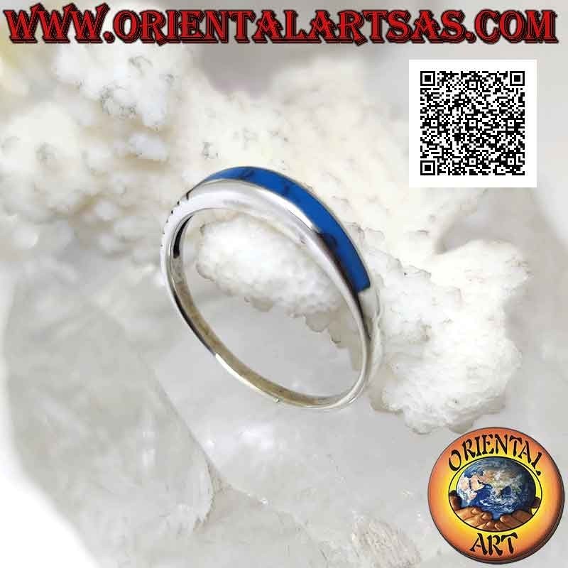 Silver ring with protruding rectangular turquoise on one side and engravings on the other