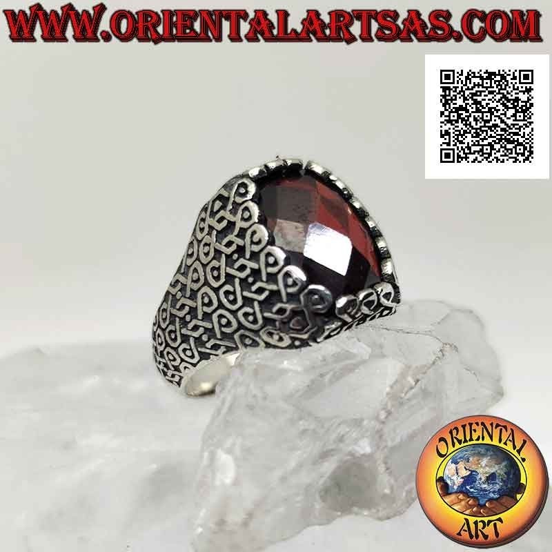 Silver ring with faceted oval garnet and geometric series of intertwined infinities on the sides