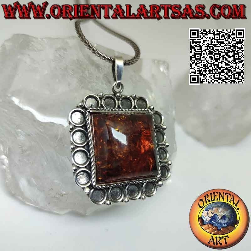 Silver pendant with large square Baltic amber with bas-relief circle frame