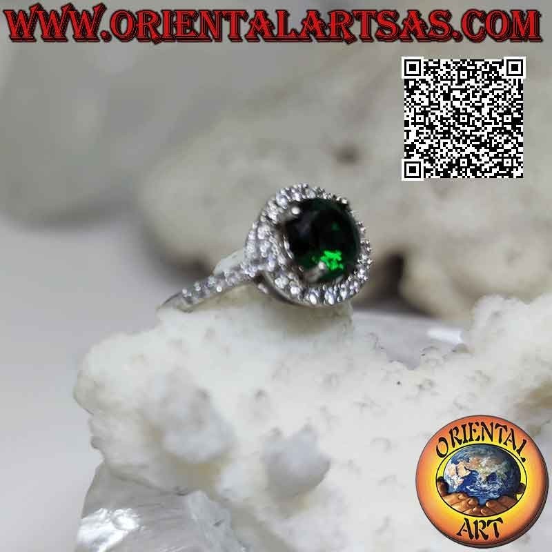 Silver ring with round synthetic emerald set surrounded by zircons and extension on the sides