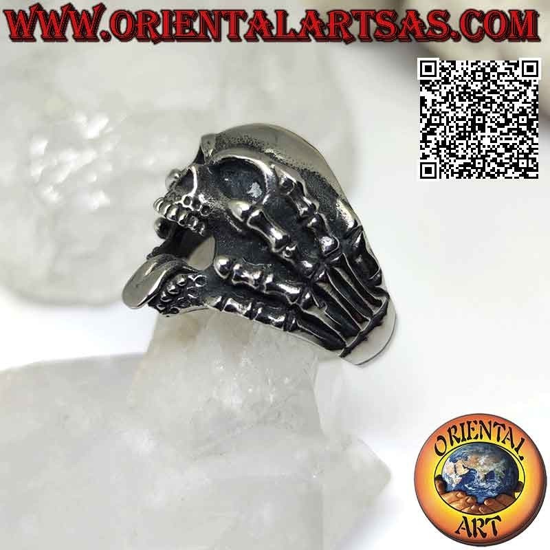 Surgical steel ring (316L), skull with tongue gripped by skeleton hands