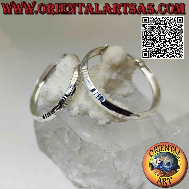 Silver baguette and horizontal 40 mm wide diamond circle earrings.