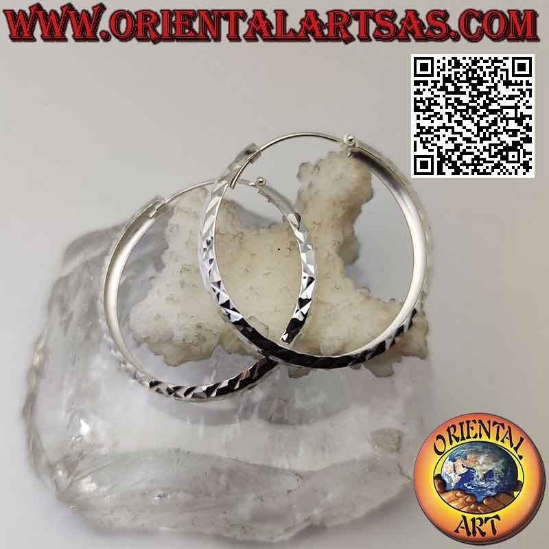 Silver earrings with a 40 mm wide diamond tragus circle.