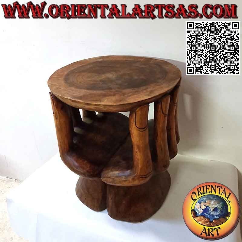 Round living room table with sculpture of two hands supporting the suar wood top (48x 46x 42)