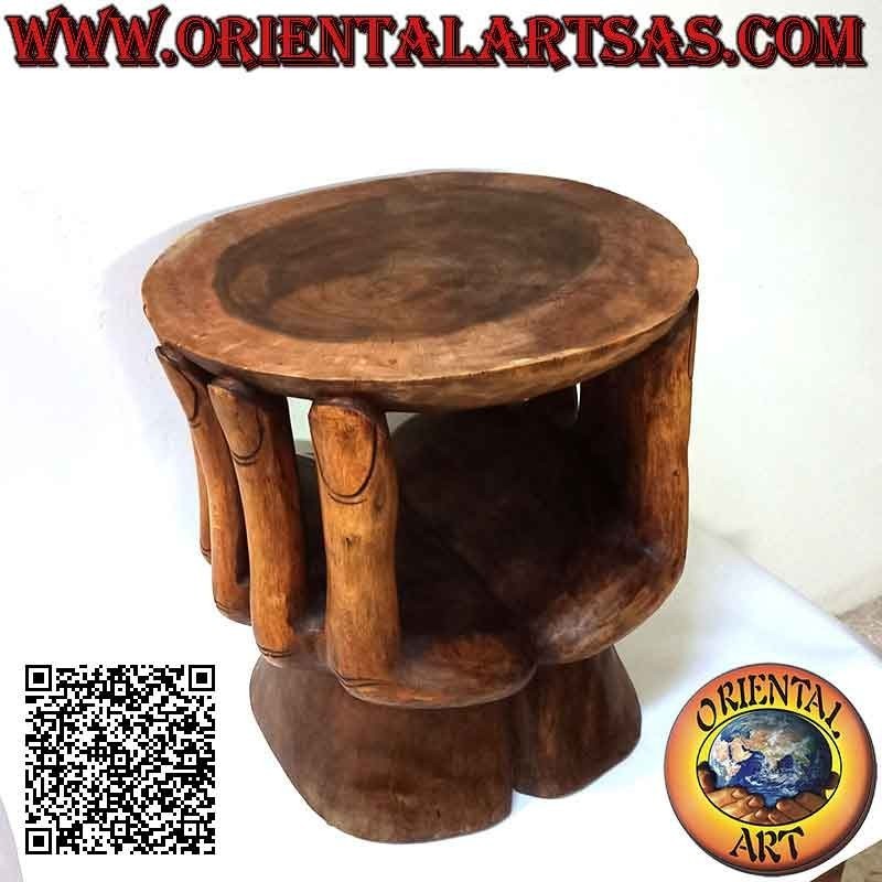 Round living room table with sculpture of two hands supporting the suar wood top (48x 46x 42)