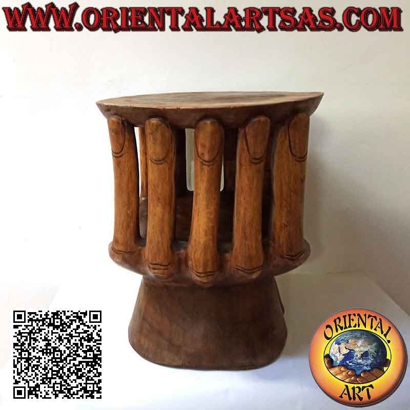 Round living room table with sculpture of two hands supporting the suar wood top (48x 46x 42)