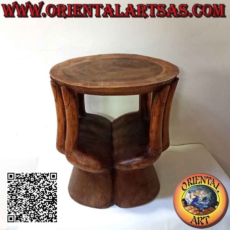 Round living room table with sculpture of two hands supporting the suar wood top (48x 46x 42)