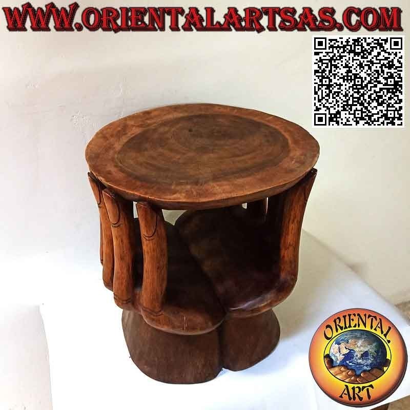 Round living room table with sculpture of two hands supporting the suar wood top (48x 46x 42)