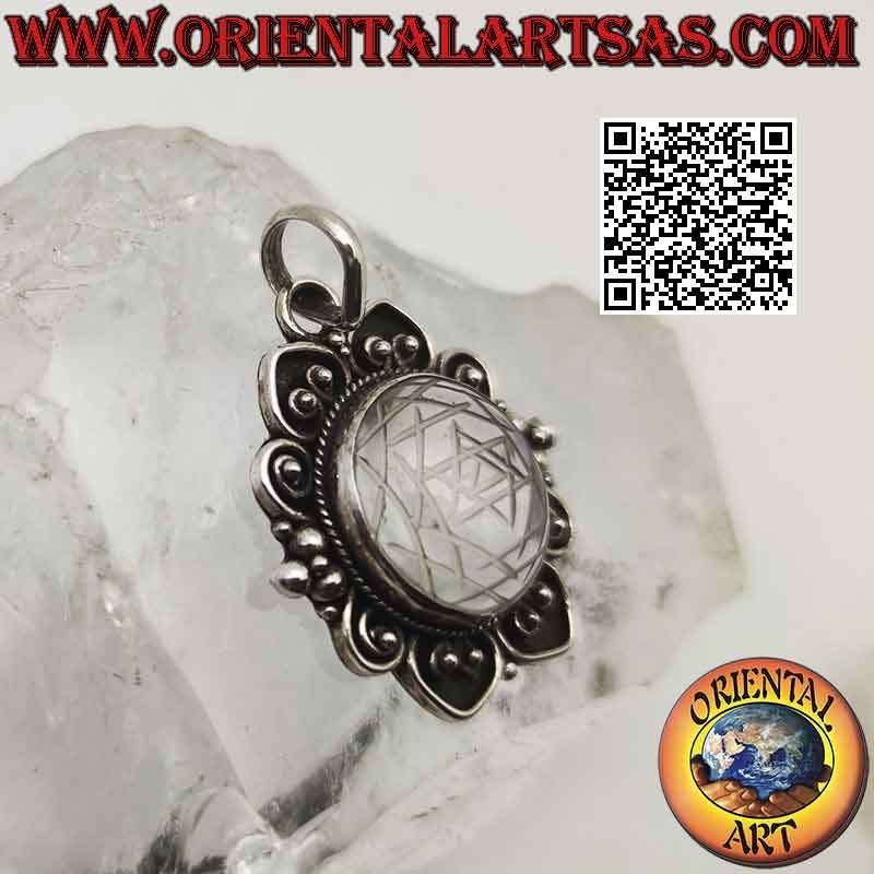 silver pendant with mandalas engraved on rock crystal