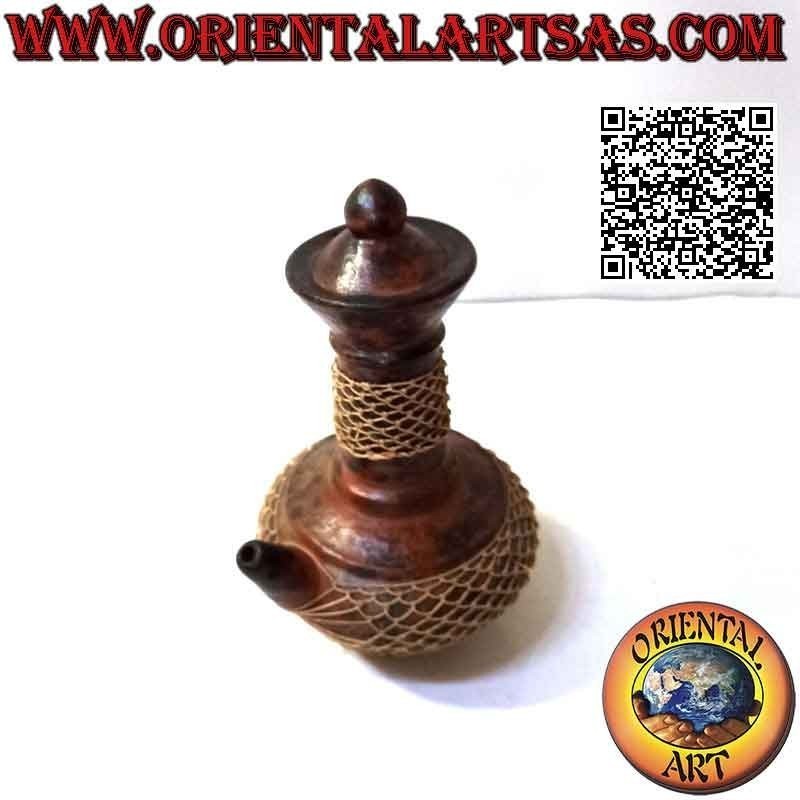 Traditional Lombok magic pitcher in terracotta and woven wicker wire, handmade