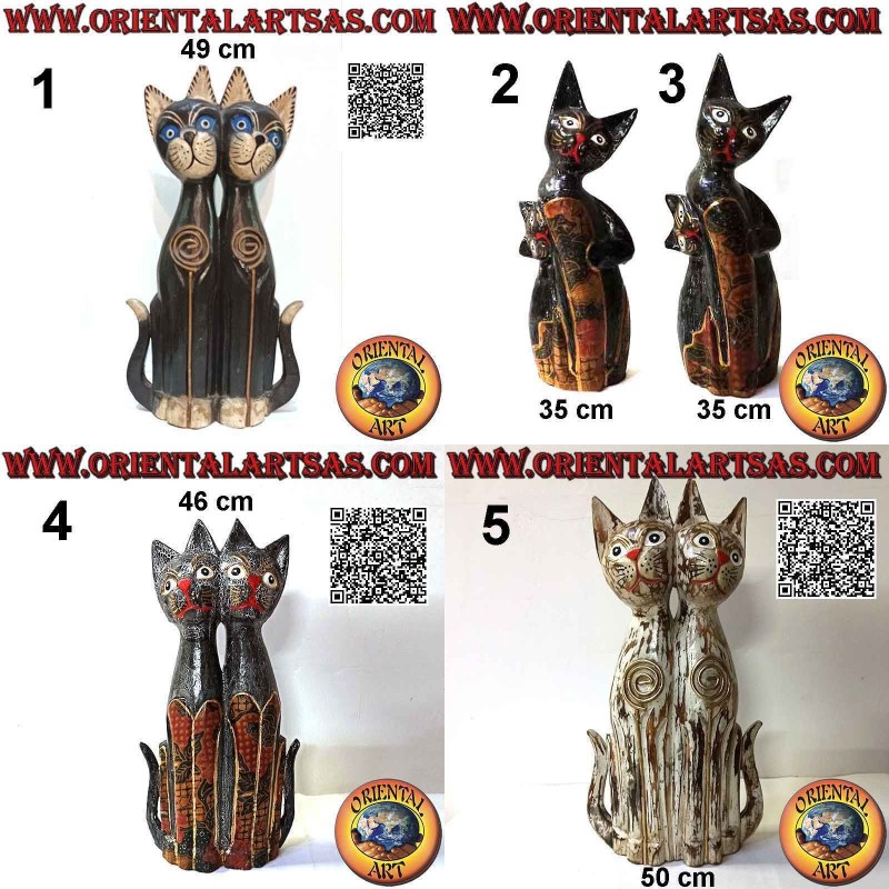 Sculpture of a couple of seated cats made and hand decorated in balsa wood