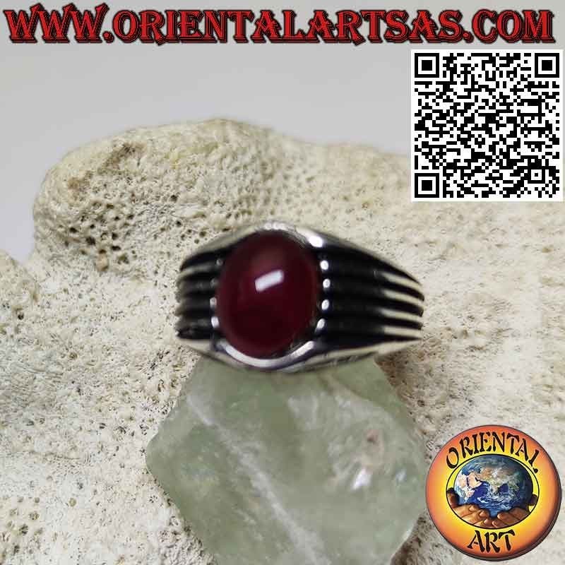 Silver ring with oval cabochon garnet and parallel lines engraved on the sides