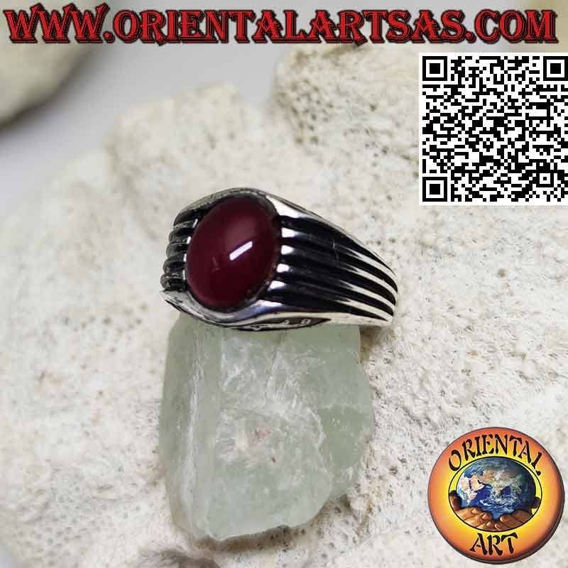 Silver ring with oval cabochon garnet and parallel lines engraved on the sides