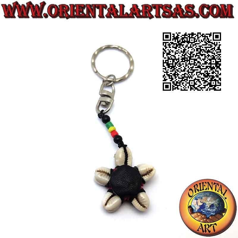 Metal keychain with a star of cauri shells knotted in the center and colored beads