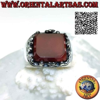Silver ring with raised rectangular carnelian framed by balls and crosses