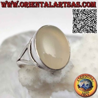 Silver ring with oval cabochon moonstone on a smooth setting of sinuous lines