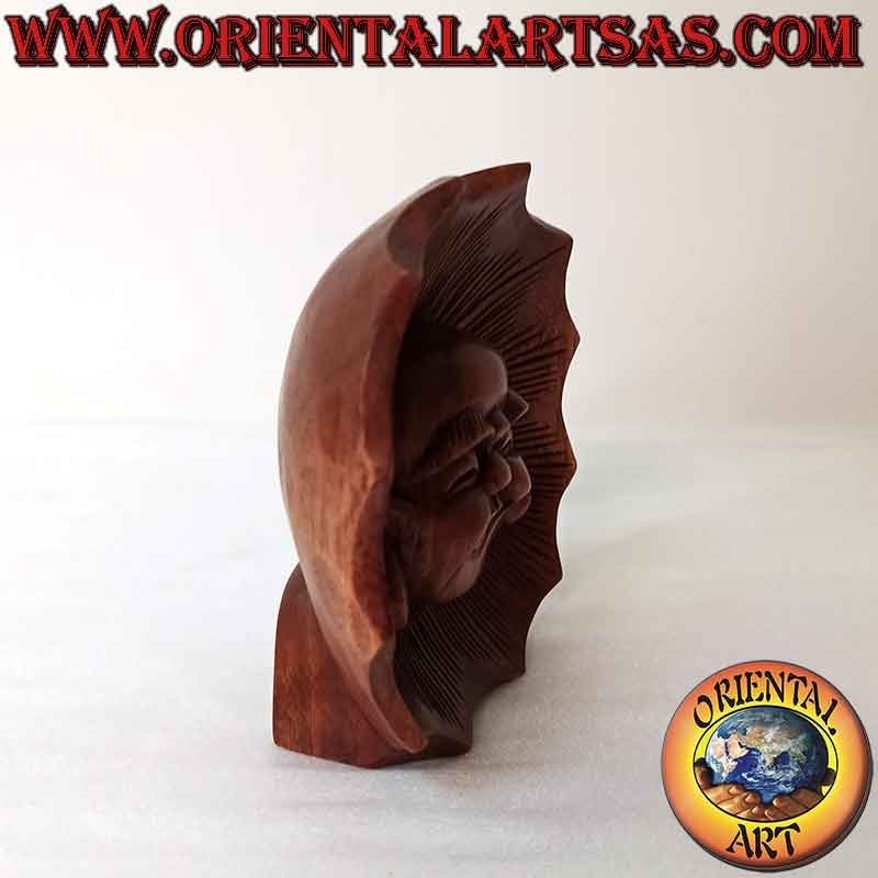 Face sculpture of the buddha of abundance carved out of suar wood